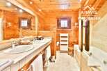 Experience the warmth of this stunning bathroom featuring natural wood finishes throughout.