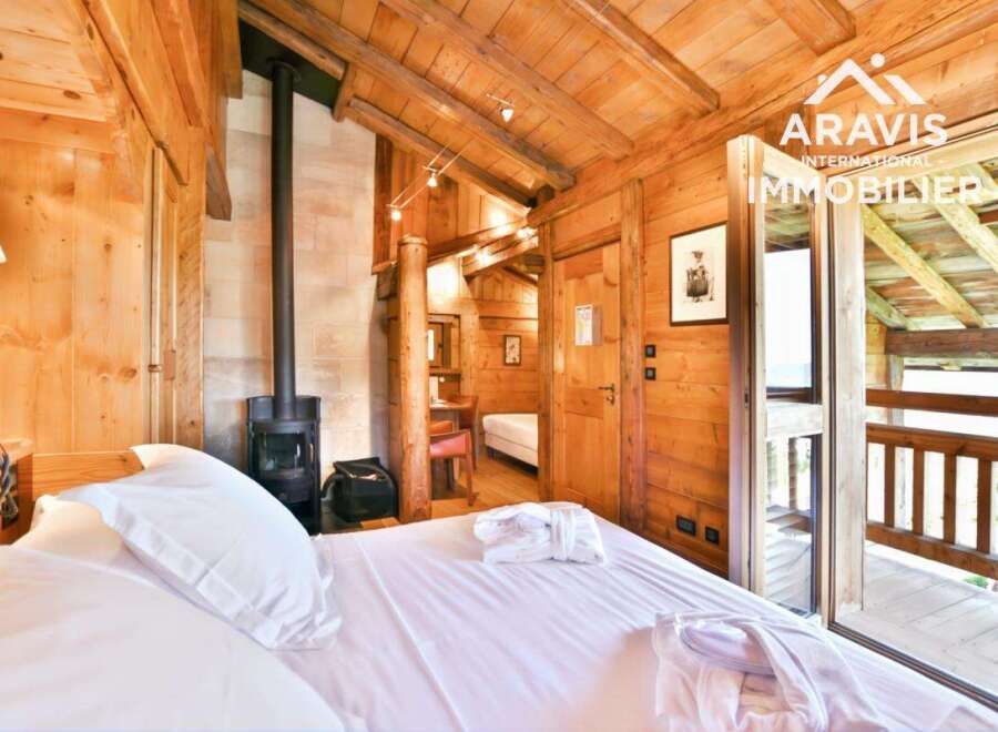 Experience the charm of this cozy wooden chalet bedroom.