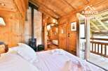 Experience the charm of this cozy wooden chalet bedroom.
