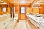 Experience luxury in this stunning bathroom featuring a jacuzzi and double sinks.