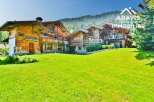 Discover a stunning chalet nestled in a picturesque mountain setting.