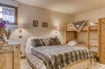 This cozy bedroom features a comfortable bed with a faux fur throw and decorative pillows, perfect for a relaxing stay.