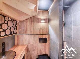 Discover the charm of this unique property, featuring a beautifully designed bathroom with a modern shower and stylish wooden accents.