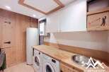 Discover the charm of this well-appointed laundry room, featuring modern appliances and ample storage.