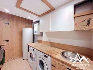 Discover the charm of this well-appointed laundry room, featuring modern appliances and ample storage.