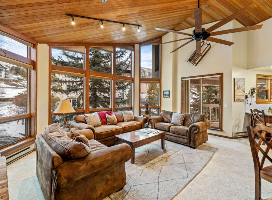 Experience luxury living in this stunning property, featuring a spacious living area with a cozy fireplace and large windows that offer breathtaking views.