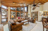 Experience luxury living in this stunning property, featuring a spacious living area with a cozy fireplace and large windows that offer breathtaking views.