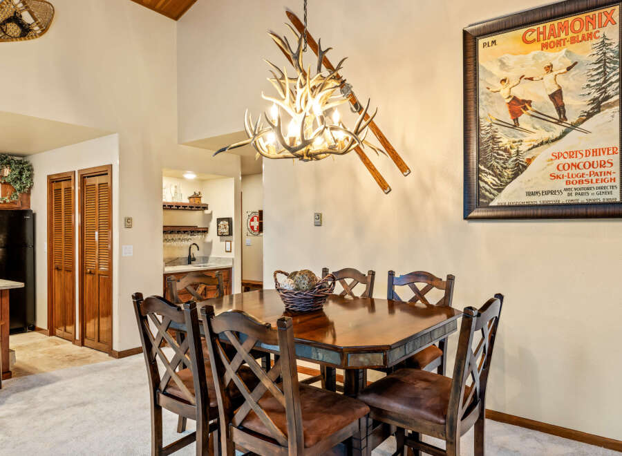 This charming dining area features a rustic wooden table and chairs, perfect for family gatherings.
