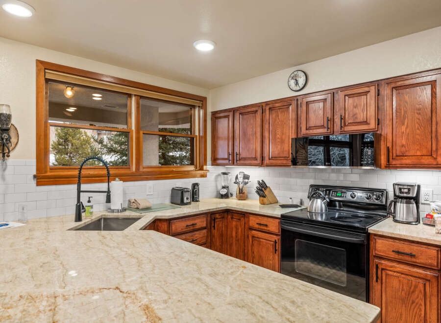 This stunning kitchen boasts beautiful wooden cabinetry and countertops, creating a warm and inviting atmosphere.
