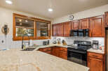 This stunning kitchen boasts beautiful wooden cabinetry and countertops, creating a warm and inviting atmosphere.