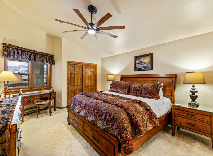 Experience luxury in this exquisite bedroom, featuring a stunning wooden bed frame and elegant nightstands.