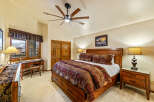 Experience luxury in this exquisite bedroom, featuring a stunning wooden bed frame and elegant nightstands.