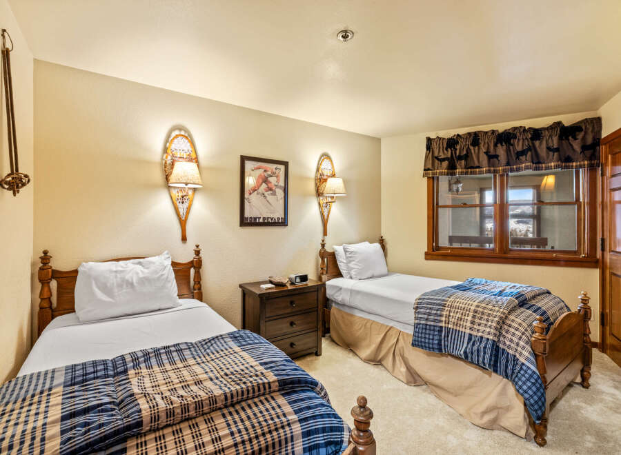 This cozy bedroom features two twin beds, perfect for guests or a shared living space.
