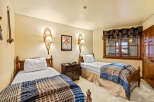 This cozy bedroom features two twin beds, perfect for guests or a shared living space.