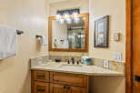This stunning bathroom boasts a rustic charm with its wooden vanity and elegant countertop.