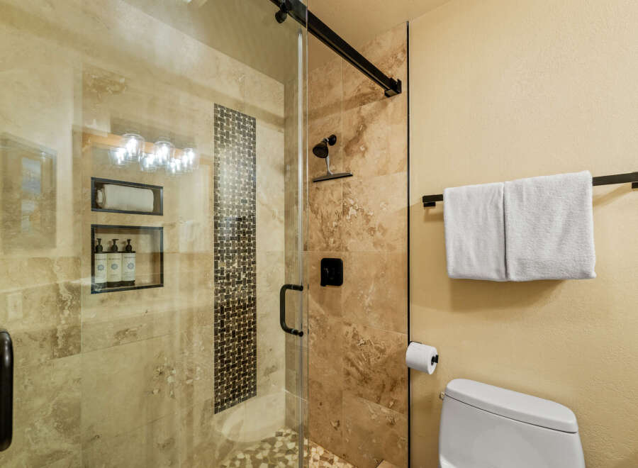 Step into luxury with this stunning bathroom! Featuring a sleek glass shower enclosure, elegant tile work, and modern fixtures, this space is designed for relaxation.