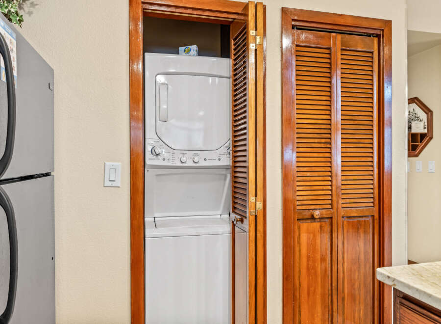 This charming property features a convenient laundry area with a stacked washer and dryer, perfect for modern living.