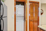 This charming property features a convenient laundry area with a stacked washer and dryer, perfect for modern living.