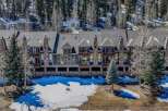 Discover luxury living in this stunning mountain property, featuring a beautiful exterior design with stone accents and a charming balcony.