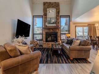 Experience luxury living in this stunning property featuring a cozy fireplace and a spacious living area.