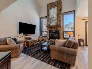 Experience luxury living in this stunning property featuring a cozy fireplace and a spacious living area.