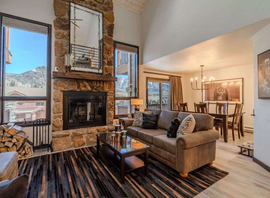 Experience luxury living in this stunning property, featuring a cozy fireplace and a spacious living area.