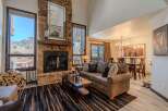 Experience luxury living in this stunning property, featuring a cozy fireplace and a spacious living area.