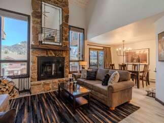 Experience luxury living in this stunning property, featuring a cozy fireplace and a spacious living area.
