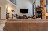 Step into luxury with this stunning living room, featuring a cozy fireplace and a large flat-screen TV perfect for entertaining.