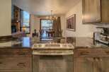 Step into luxury with this stunning kitchen, featuring sleek countertops and modern appliances.