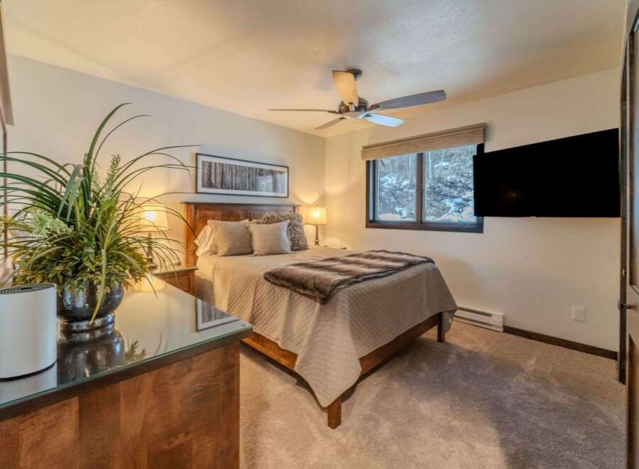 This cozy bedroom features a comfortable bed with a stylish comforter and pillows, perfect for a relaxing night's sleep.