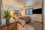 This cozy bedroom features a comfortable bed with a stylish comforter and pillows, perfect for a relaxing night's sleep.