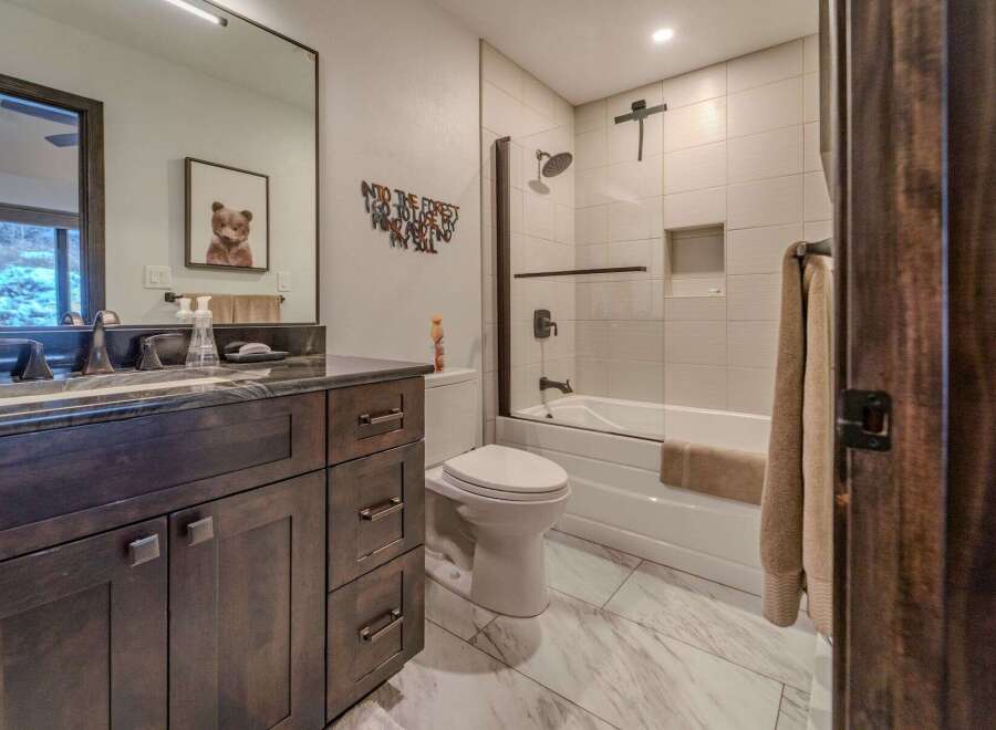 Step into this beautifully designed bathroom, featuring a modern vanity with ample storage and a sleek countertop.