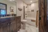 Step into this beautifully designed bathroom, featuring a modern vanity with ample storage and a sleek countertop.