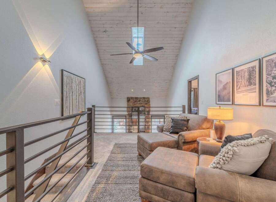 This stunning property boasts a modern, open-concept design with a vaulted ceiling and ample natural light.