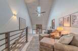 This stunning property boasts a modern, open-concept design with a vaulted ceiling and ample natural light.