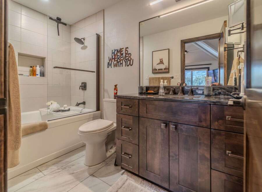 Step into this beautifully designed bathroom, featuring a modern aesthetic with a touch of rustic charm.