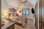 This cozy bedroom features a comfortable bed with plush bedding, perfect for a relaxing retreat.