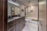 Step into luxury with this stunning bathroom, featuring a sleek vanity and a modern design.