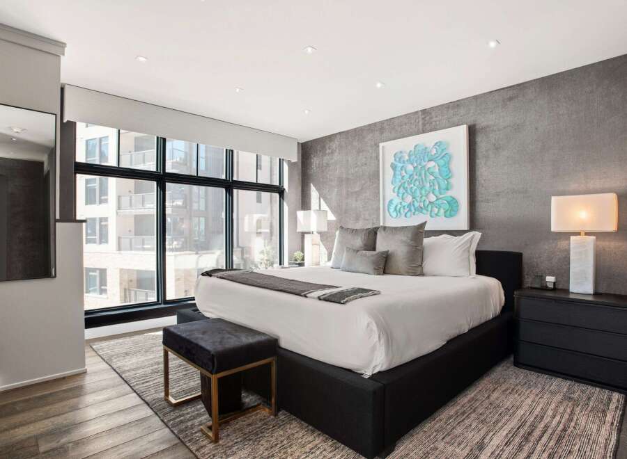 Experience luxury in this stunning bedroom featuring a modern design and high-end finishes.
