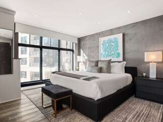 Experience luxury in this stunning bedroom featuring a modern design and high-end finishes.
