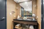 This luxurious bathroom boasts a sleek, modern design with a double vanity and a large mirror.