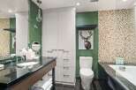 This modern bathroom boasts a sleek design with a combination of functionality and style.