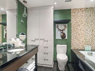 This modern bathroom boasts a sleek design with a combination of functionality and style.