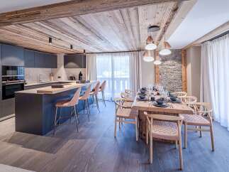 Experience luxury living in this stunning property, featuring a modern kitchen with sleek cabinetry and a spacious island perfect for entertaining.