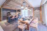 Experience luxury living in this stunning property featuring a modern kitchen with sleek cabinetry and a breakfast bar.
