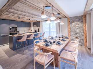 Experience luxury living in this stunning property featuring a modern kitchen with sleek cabinetry and a breakfast bar.