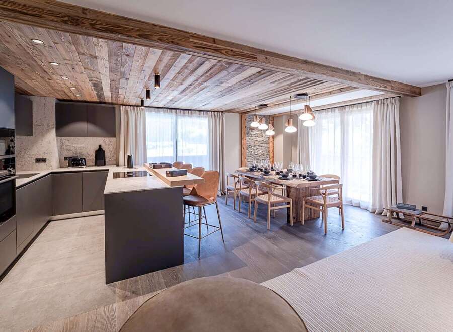 This stunning property boasts a modern kitchen with sleek cabinetry and a spacious island, perfect for culinary enthusiasts.