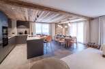This stunning property boasts a modern kitchen with sleek cabinetry and a spacious island, perfect for culinary enthusiasts.