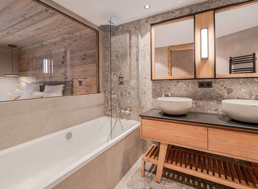 Experience luxury in this stunning bathroom, featuring a modern design with a touch of rustic charm.
